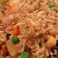Pineapple Fried Rice · With egg chicken, pork, shrimp. Sliced pineapple, peas, and carrot cashew nut with curry pow...