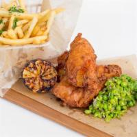 Fish And Chips · Malt beer-battered cod fish with sautéed peas, fries, and tartar sauce.