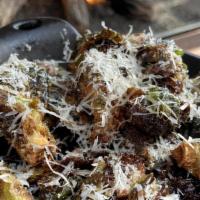Crispy Brussel Sprouts · Roasted Brussels sprouts, tossed in sweet chili sauce garnished with shaved Parmigiana and c...