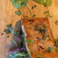 Seared Salmon Salad · Arugula, Seared coho salmon, avocado cilantro dressing, red radish, cherry tomato, pickled o...