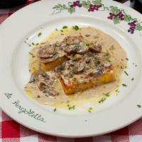 Polenta Grigliata · Grilled polenta topped with cream of mushrooms; porcini, portobello, and parisian.