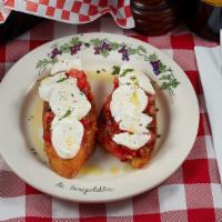 Bruschetta Mozzarella · Two slices of toasted homemade garlic bread topped with fresh tomatoes, basil, olives, and m...