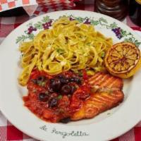 Salmone In Guazzetto · Salmon in casserole, with tomato basil sauce, capers, and olives. Served with fettuccine sau...