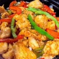 Pepper Orange Chicken · Marinated chicken bites sautéed in bell peppers & onions and orange sauce over white rice.