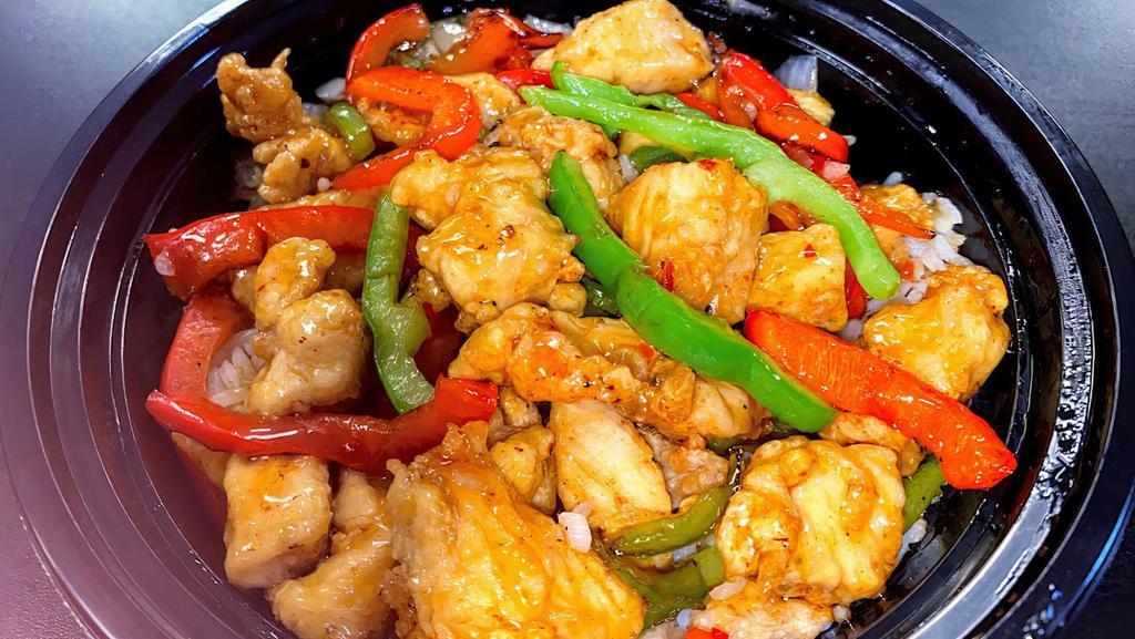 Pepper Orange Chicken · Marinated chicken bites sautéed in bell peppers & onions and orange sauce over white rice.