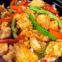 Pepper Sweet & Sour Chicken · Marinated chicken bite sautéed in bell peppers & onions and sweet & sour sauce over white ri...