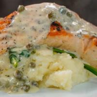 Grilled Salmon · With caper cream lemon sauce served with mashed potatoes and veggies.