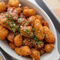 Fried Cheddar Cheese Curds · fried cheddar cheese curds served with our savory poutine gravy