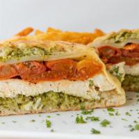 Chicken Pesto Panini · grilled chicken breast, roasted roma tomatoes, swiss and cilantro arugula pesto on grilled c...