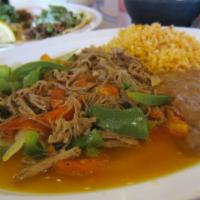 Ropa Vieja Ó Machaca · Shredded beef in a red tomato sauce or with onions tomatoes & bell peppers