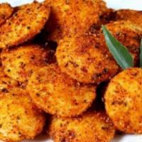 Ghee Podi Mini Idly · Dollar coin sized small steamed rice and lentil patties fried with spicy dhal mix powder.