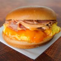 Brioche, Ham, Egg, & Cheddar Sandwich · 2 scrambled eggs, melted Cheddar cheese, sliced ham, and Sriracha aioli on a warm brioche bun.