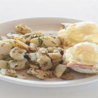 Eggs Benedict · Two poached eggs, ham steak, English muffin, hollandise sause, country potatoes.