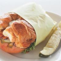 Pesto Chicken Sandwich · Chicken breast, lettuce, tomato, onions, pickles, house pesto dressing, on a croissant.