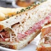 Reuben Sandwich · Thickly sliced and made from scratch is our corned beef covered in melted swiss cheese, saue...