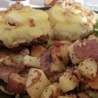 Classic Eggs Benedict · Two poached eggs, a toasted English muffin, and Canadian bacon. Topped with our homemade hol...