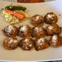 Garnachas · Ten corn tortillas topped with meat or chicken. Cabbage salad and sauce on the side.