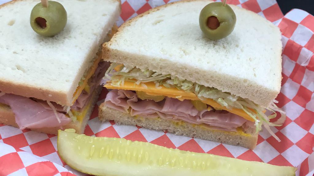 Tim Allen · Stacked metro Deli ham on sourdough with pepper rings, mayo, mustard, lettuce, & thickly cut cheddar cheese.