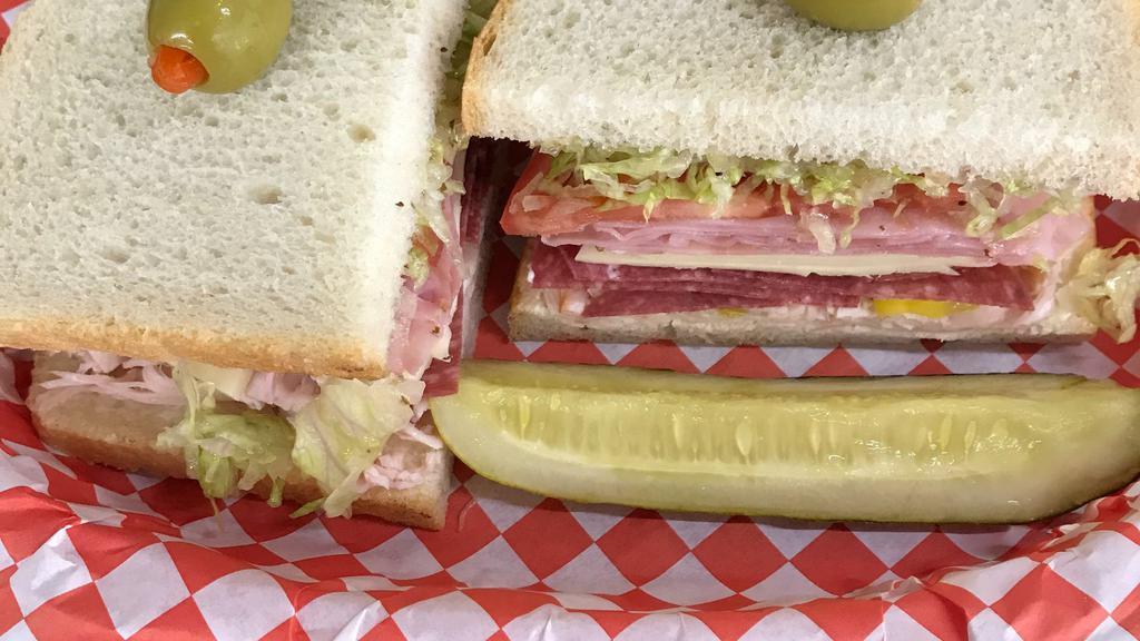 The Dagwood · Enough to fill the hungriest cartoon. Turkey, pepper rings, salami, jack cheese, & ham are topped with tomato, lettuce, mayo and Italian dressing on sourdough.