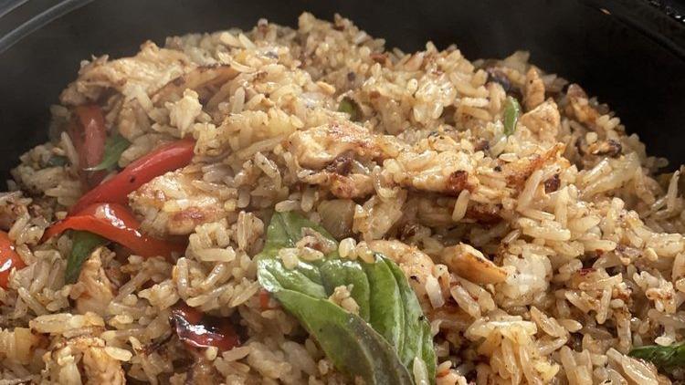 Spicy Fried Rice · Jasmine rice, roasted chili and garlic, egg, onion, red bell pepper, basil, and homemade basil sauce.