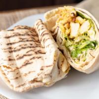 Chicken Shawarma · Thin slices of spiced grilled chicken with tomato, pickles, parsley, tahini sauce in pita br...