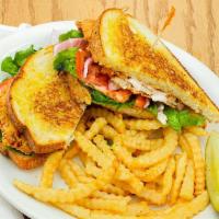 Fried Chicken Sandwich · Breaded chicken breast with lettuce, tomatoes, onions, and sauce on sourdough bread.