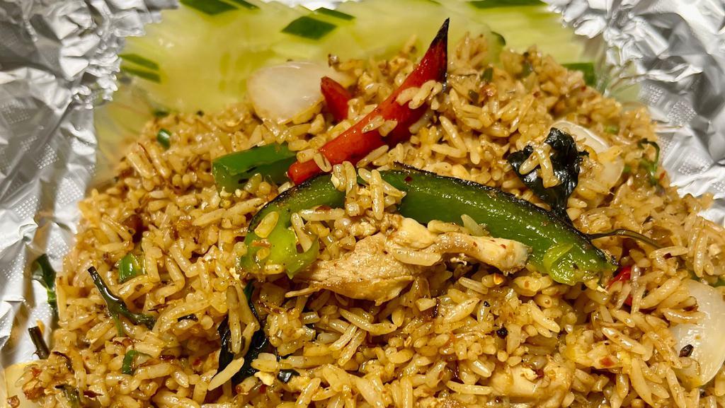 Spicy Fried Rice · Thai style fried rice with your choice of meat, eggs, chili, onions, bell peppers and basil leaves.