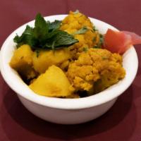 Aloo Gobi · Potatoes and cauliflower in dry curry sauce.