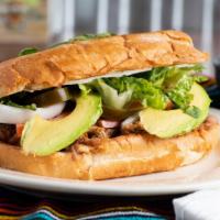 Torta (Mexican Sandwich) · Includes: meat, beans, lettuce, tomato, jalapenos, avocado, onion, sour cream.