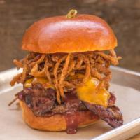 Goodland · crispy onion strings, sliced bratwurst, smoked bacon, cheddar cheese, bbq sauce