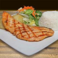 Salmon A La Parrilla · Grilled salmon, served with fried potato and steamed rice or vegetables.