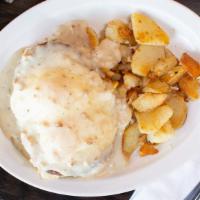 Country Benedict · Home-made buttermilk biscuits, two sausage patty, two eggs, and country sausage gravy with b...