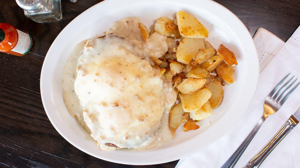 Country Benedict · Home-made buttermilk biscuits, two sausage patty, two eggs, and country sausage gravy with breakfast potatoes.