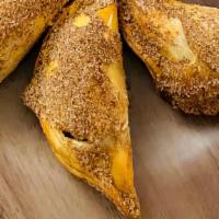 Apple Pie Churro Empanada · Our apple pie churro empanada is a delicious combination of apple pie and churros, finished ...