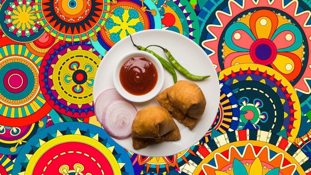 Samosa Surprise  · Triangle shaped deep fried pastry dumplings filled with spiced potatoes and vegetables