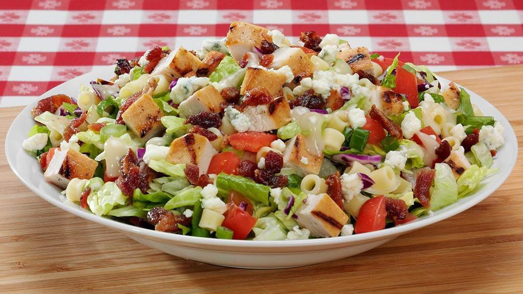 Chopped Salad · Everything includes chopped romaine, iceberg lettuce, & red cabbage with diced chicken breast, ditalini pasta, bacon, diced tomatoes, gorgonzola cheese, and green onion. House dressing served on the side.