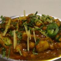Aloo Sholle (Vegan) · Garbanzo beans and potatoes cooked in special blend of spices.