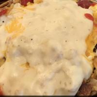 Rosie'S Skillet · Scrambled eggs with diced ham, bacon, sausage, bell peppers and onions topped with cheese.