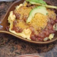 Chili Skillet · Scrambled eggs topped with chili and cheese. (onions upon request).