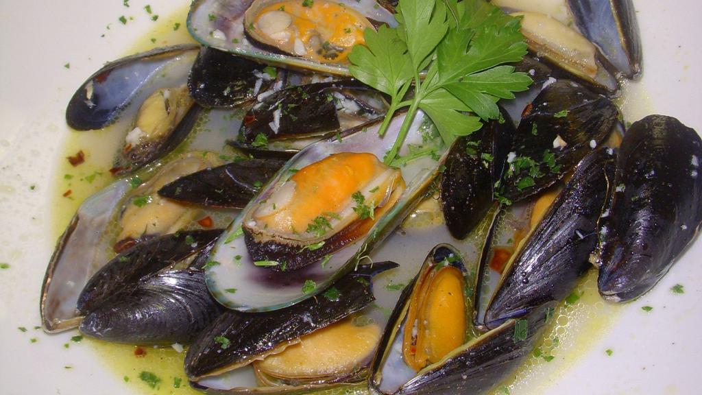 Black Mussels · Simmered in garlic white wine broth and fresh-diced tomatoes.