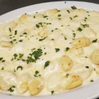 Gnocchi · Potato dumplings baked with meat sauce or alfredo sauce and mozzarella cheese.