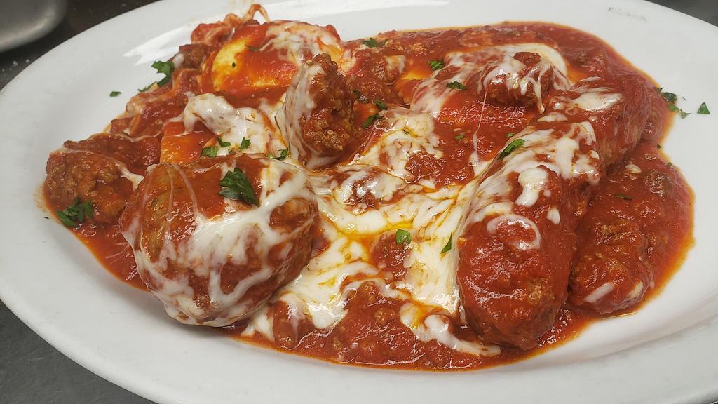 Classic Combo · Two cheese ravioli, one manicotti, one sausage, one meatball, baked with meat sauce, and Mozzarella.