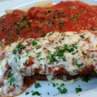 Chicken Parmigiana · Crispy chicken breast baked with marinara sauce, mozzarella cheese and served with a side of...