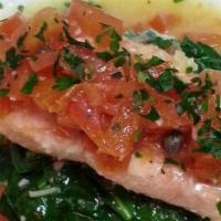 Baked Wild Salmon · Wild salmon filet baked in garlic, white wine, lemon, tomatoes, and capers. Served over stea...