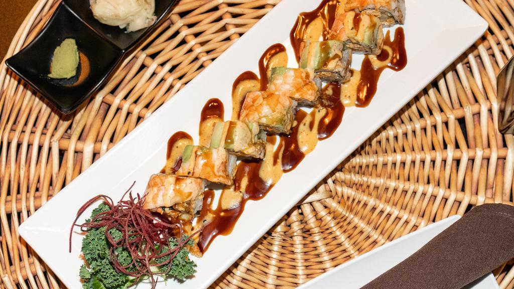Tiger Roll · Inside: shrimp tempura, spicy crabmeat and cucumber. 
Outside: shrimp and avocado.