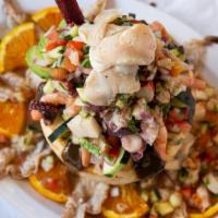 El Coco Loco · Coconut meat, fish ceviche, butterflied shrimp, scallop, cooked shrimp, octopus, and imitati...