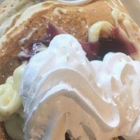 Y. Cheesecake Pancakes · Three buttermilk pancakes stuffed with white chocolate chips and smothered in our cheesecake...