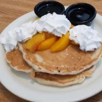 Tooty Fruity Pancakes · Three buttermilk pancakes topped with your choice of blueberry, strawberry, cherry, cinnamon...