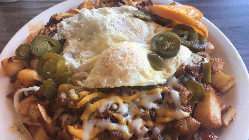 Hot Juan Skillet · Skillet potatoes covered with chorizo, green chillies, onions and crispy jalapenos with Cheddar and jack cheese. Topped with two eggs.