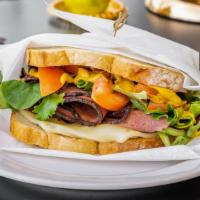 Pastrami Sandwich · Pastrami, swiss cheese, mixed greens and tomatoes on lightly toasted white bread. Also comes...